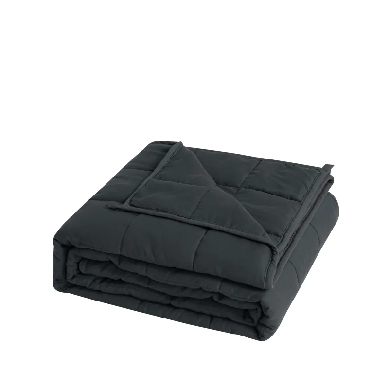 Couverture lestée grise pour adulte, pliée, matelassage en carrés cousus